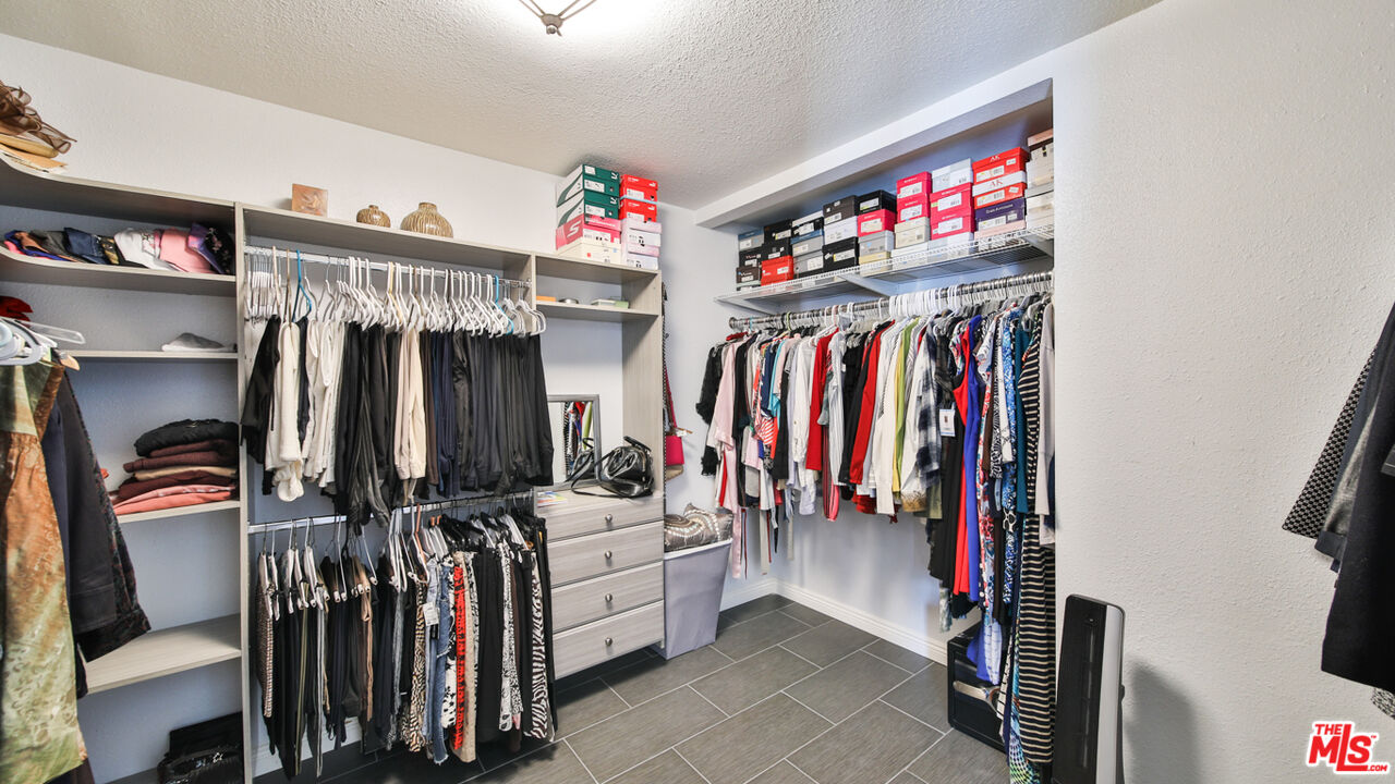 16953 Roa Drive Carson, CA 90746 - Photo 37 of 48 a view of walk in closet with clothes and shoes