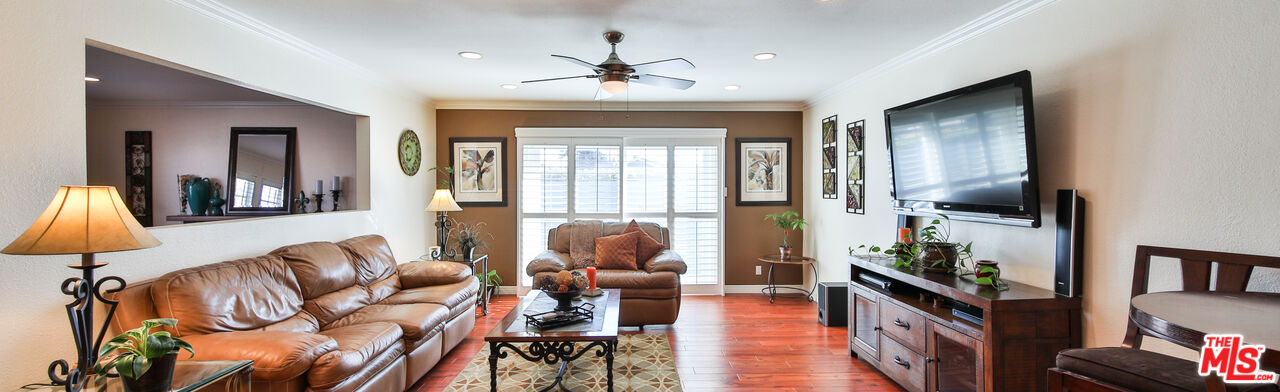 16953 Roa Drive Carson, CA 90746 - Photo 5 of 48 a living room with furniture a chandelier and a floor to ceiling window