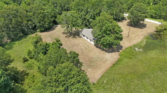 a view of a lake with large trees
