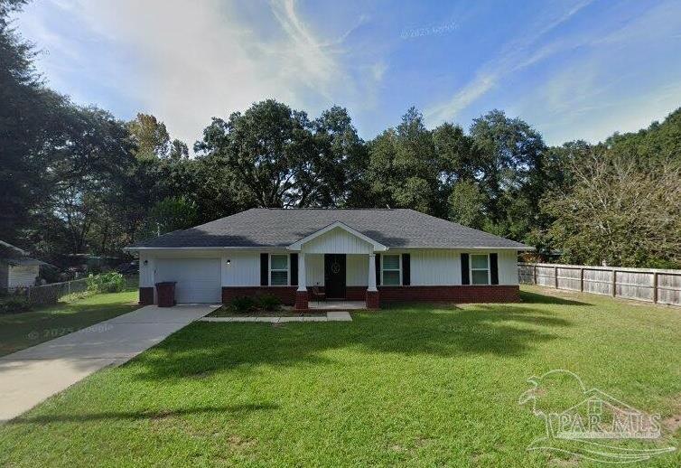 5538 Holley Street Milton, FL 32583 - Photo 1 of 6 a front view of a house with a yard table and chairs