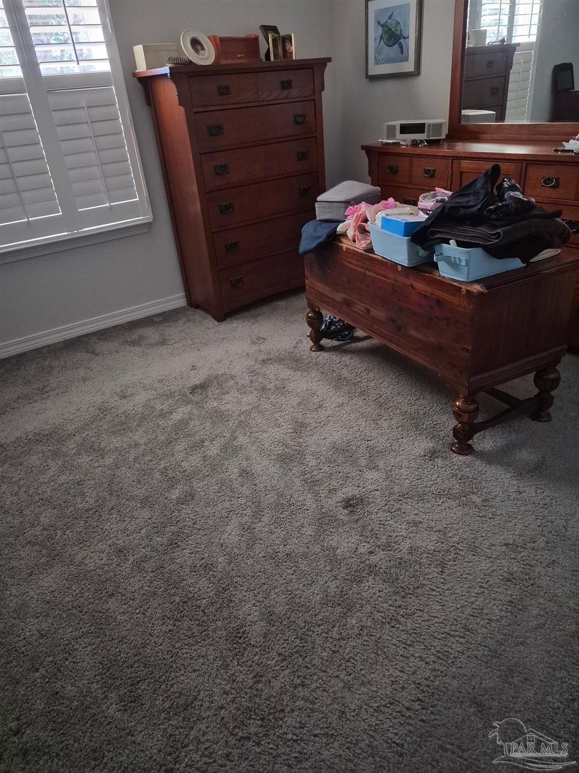5538 Holley Street Milton, FL 32583 - Photo 2 of 6 a blue bed sitting in a room next to a window