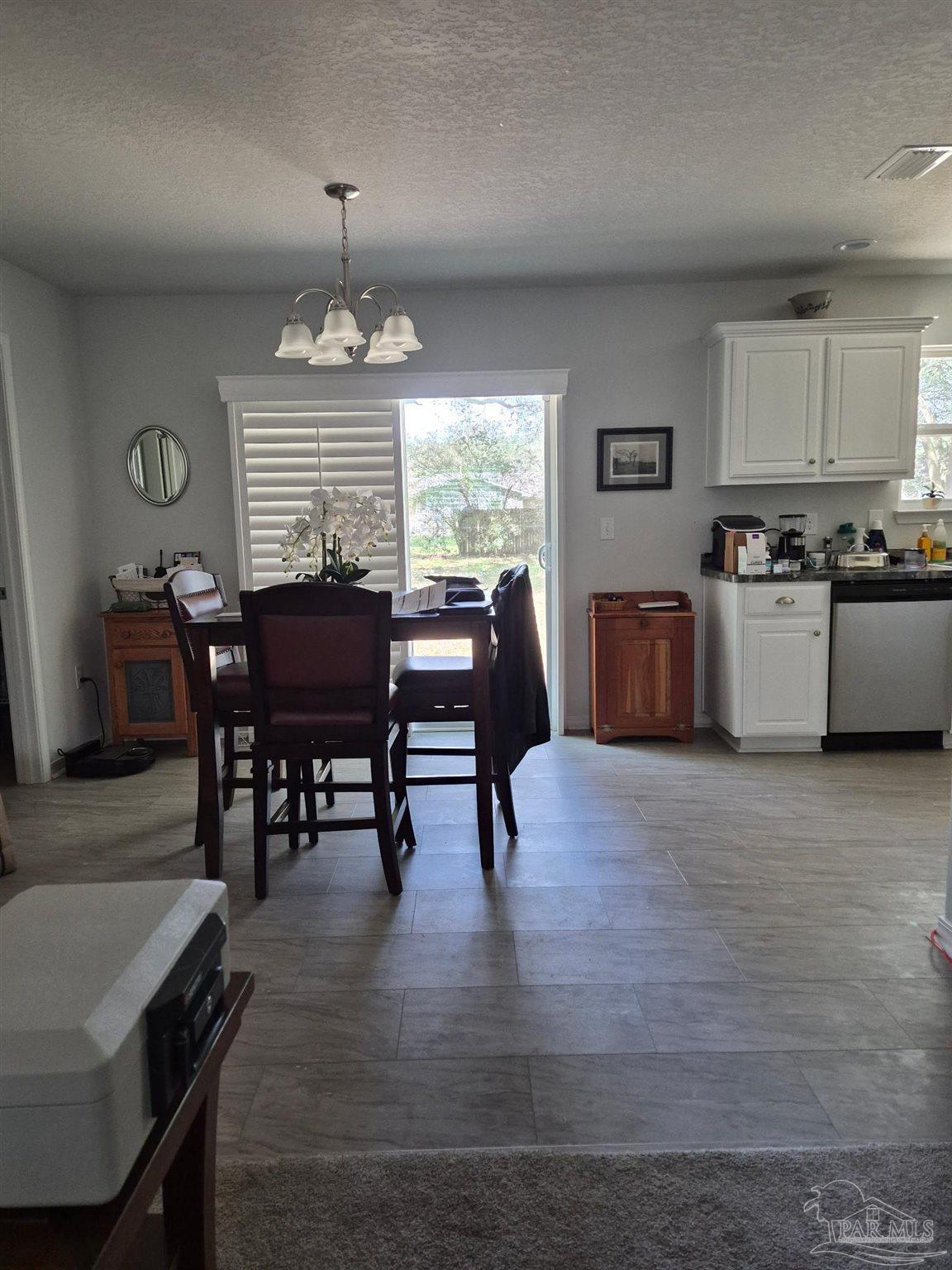 5538 Holley Street Milton, FL 32583 - Photo 6 of 6 a view of a dining room with furniture window and wooden floor