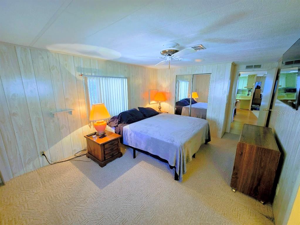 12501 Ulmerton Road, Unit 188 Largo, FL 33774 - Photo 34 of 63 a spacious bedroom with a bed and wooden floor