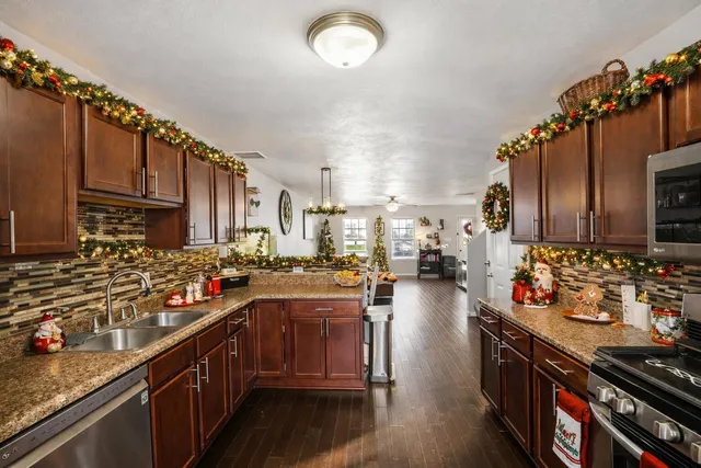 a kitchen with lots of counter top space and wooden floor