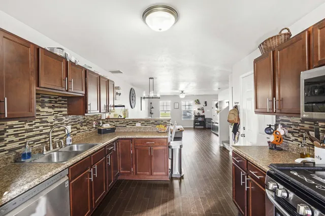 a kitchen with lots of counter top space a sink and appliances