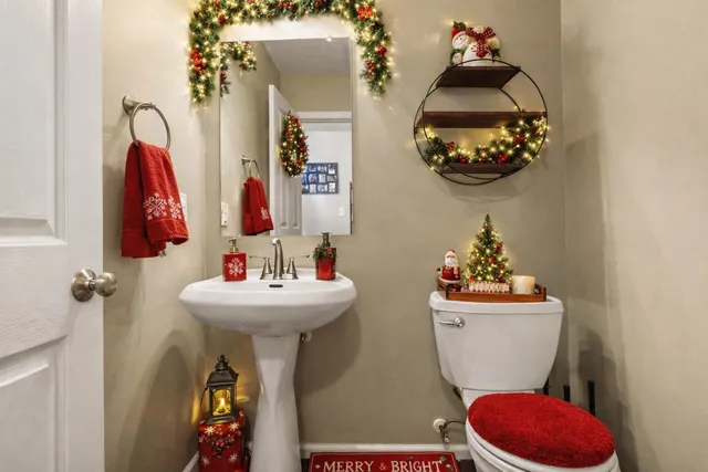a bathroom with a sink mirror and toilet