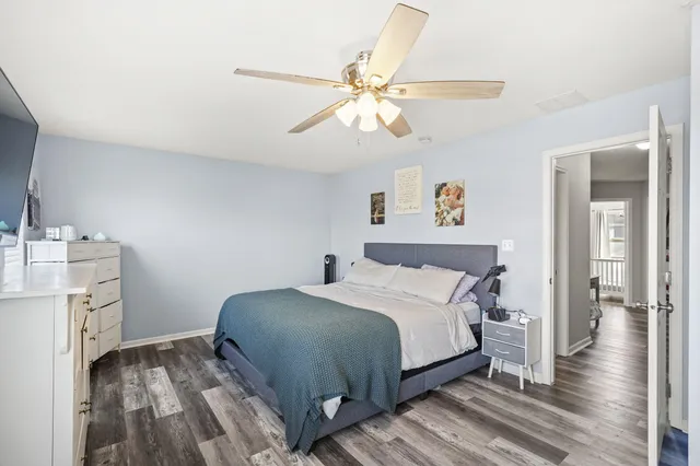 a bedroom with a bed and wooden floor