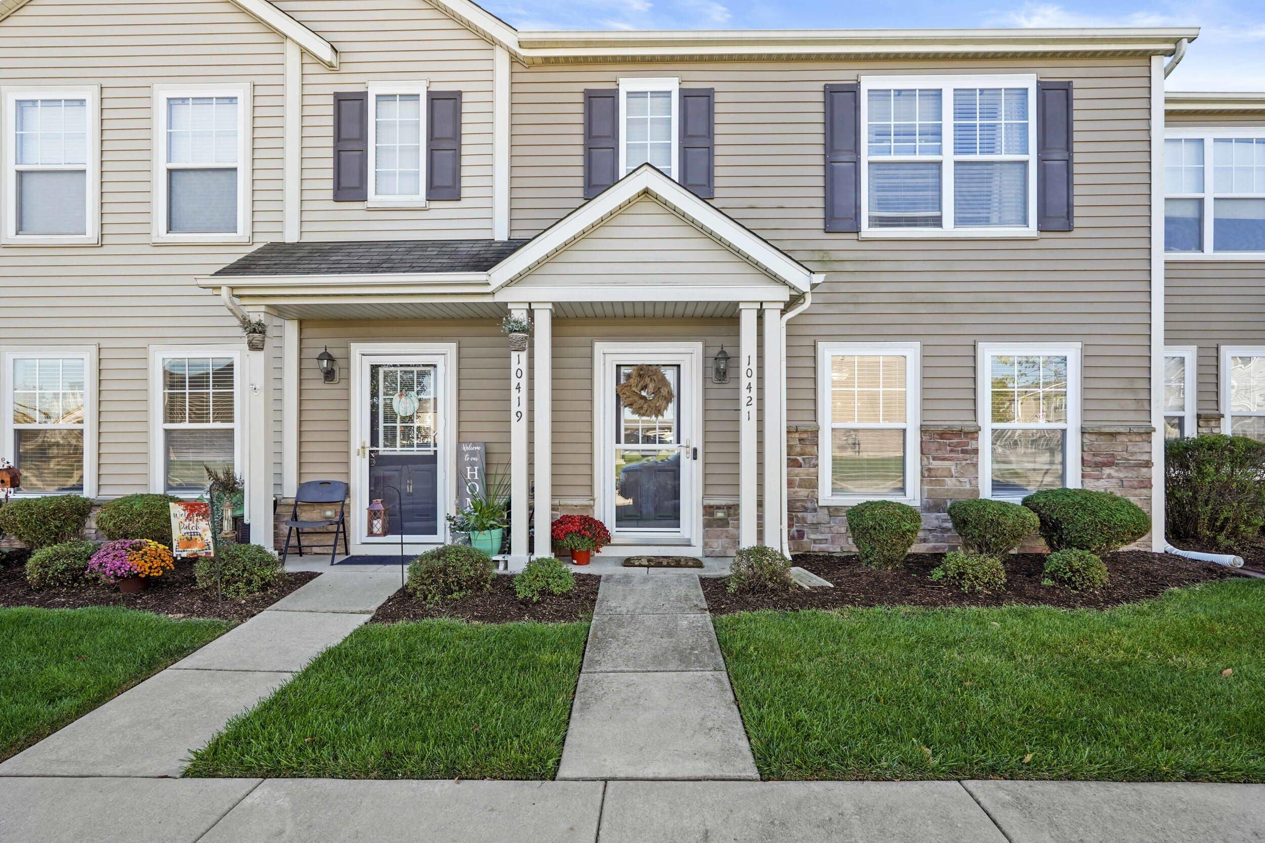 10421 Paramount Way Cedar Lake, IN 46303 - Photo 2 of 26 a front view of a house with a yard and potted plants