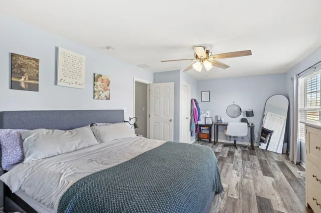 a bedroom with a bed and a chandelier