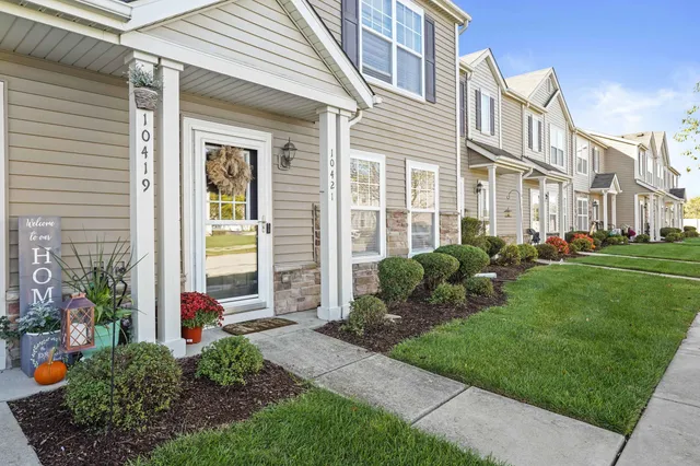 a view of a house with a yard and plants