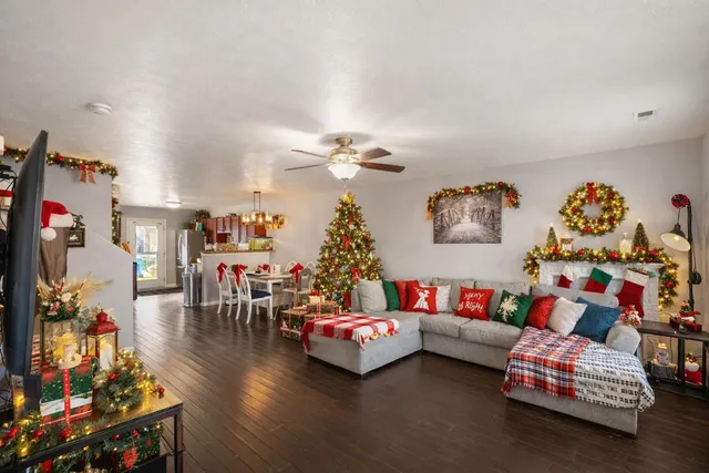 a living room with furniture and a chandelier