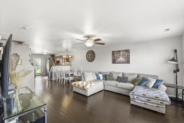 a living room with furniture and a chandelier