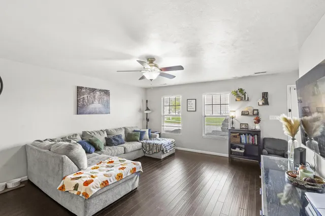 a living room with furniture and wooden floor