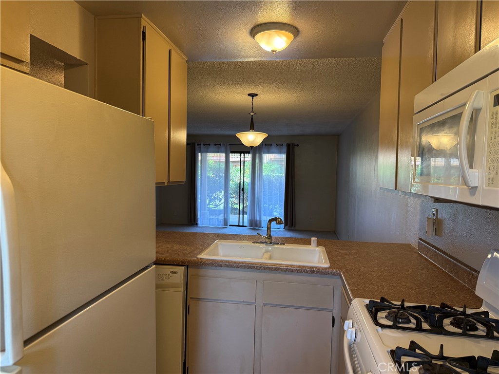 122 Tangelo Irvine, CA 92618 - Photo 15 of 34 a view of a kitchen with a stove and a window