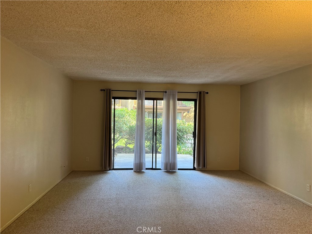 122 Tangelo Irvine, CA 92618 - Photo 4 of 34 an empty room with windows