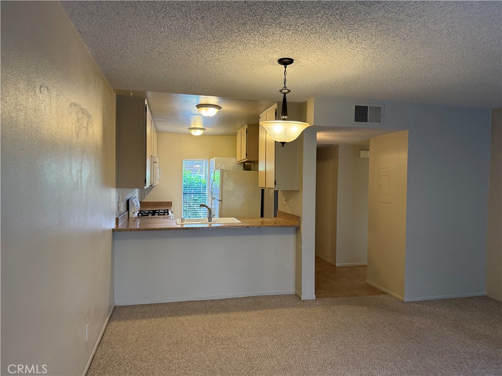 122 Tangelo Irvine, CA 92618 - Photo 6 of 34 a kitchen with stainless steel appliances a refrigerator and a sink