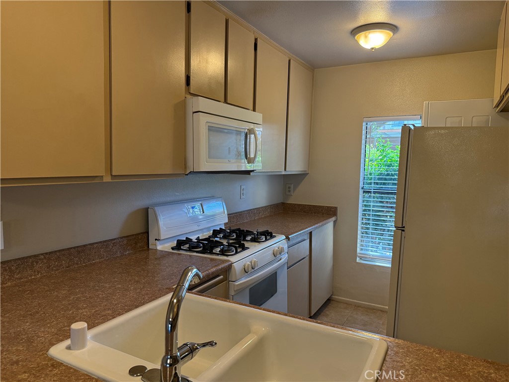 122 Tangelo Irvine, CA 92618 - Photo 8 of 34 a kitchen with stainless steel appliances granite countertop a sink and a stove