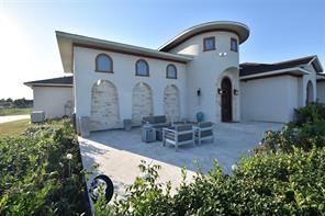 a front view of house with yard and outdoor seating