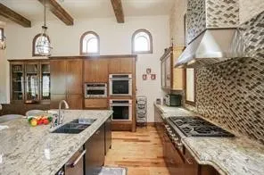 a kitchen with stainless steel appliances granite countertop a stove and a sink