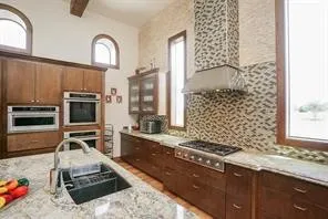 a kitchen with sink stove and cabinets