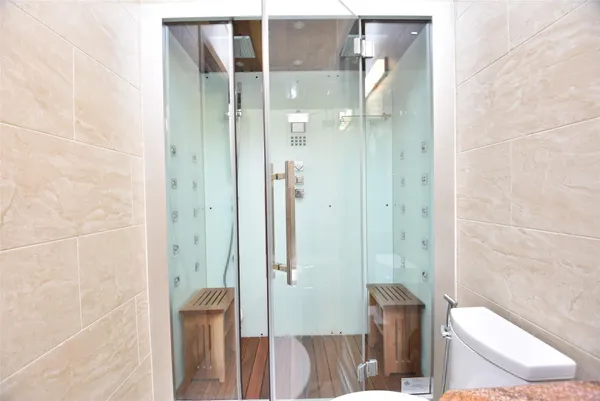 a bathroom with a glass shower door