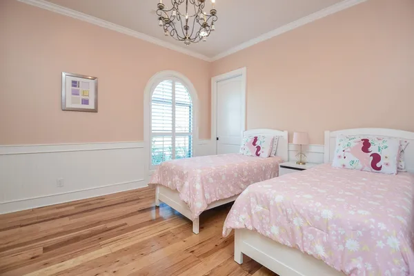 a bedroom with two beds and a window