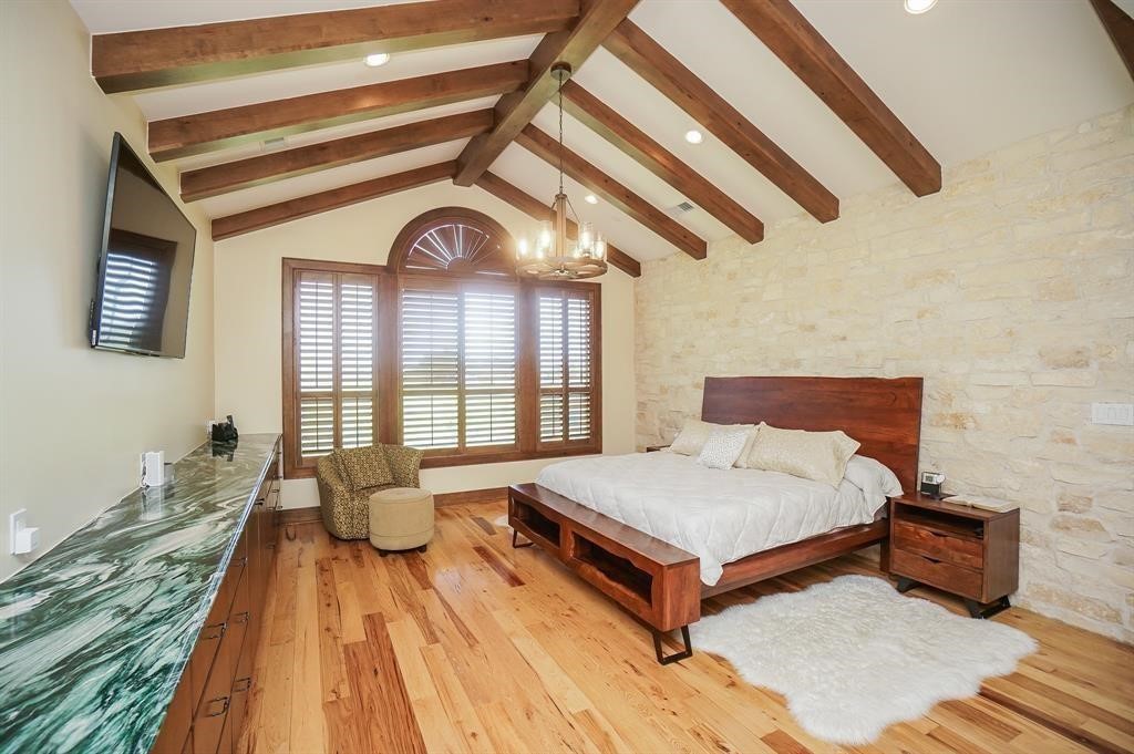 825 Grubbs Road Sealy, TX 77474 - Photo 29 of 49 a spacious bedroom with a bed and wooden floor