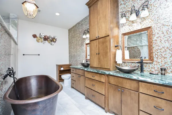 a kitchen with stainless steel appliances granite countertop a sink a stove and a window
