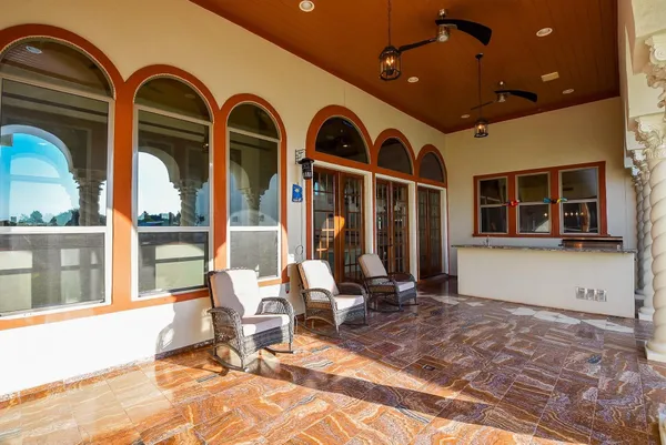 a front view of a house with outdoor seating