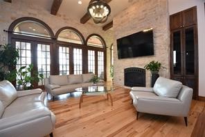 825 Grubbs Road Sealy, TX 77474 - Photo 9 of 49 a living room with furniture a fireplace and a flat screen tv