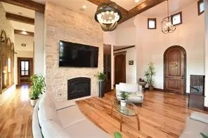 a living room with furniture a fireplace and a flat screen tv