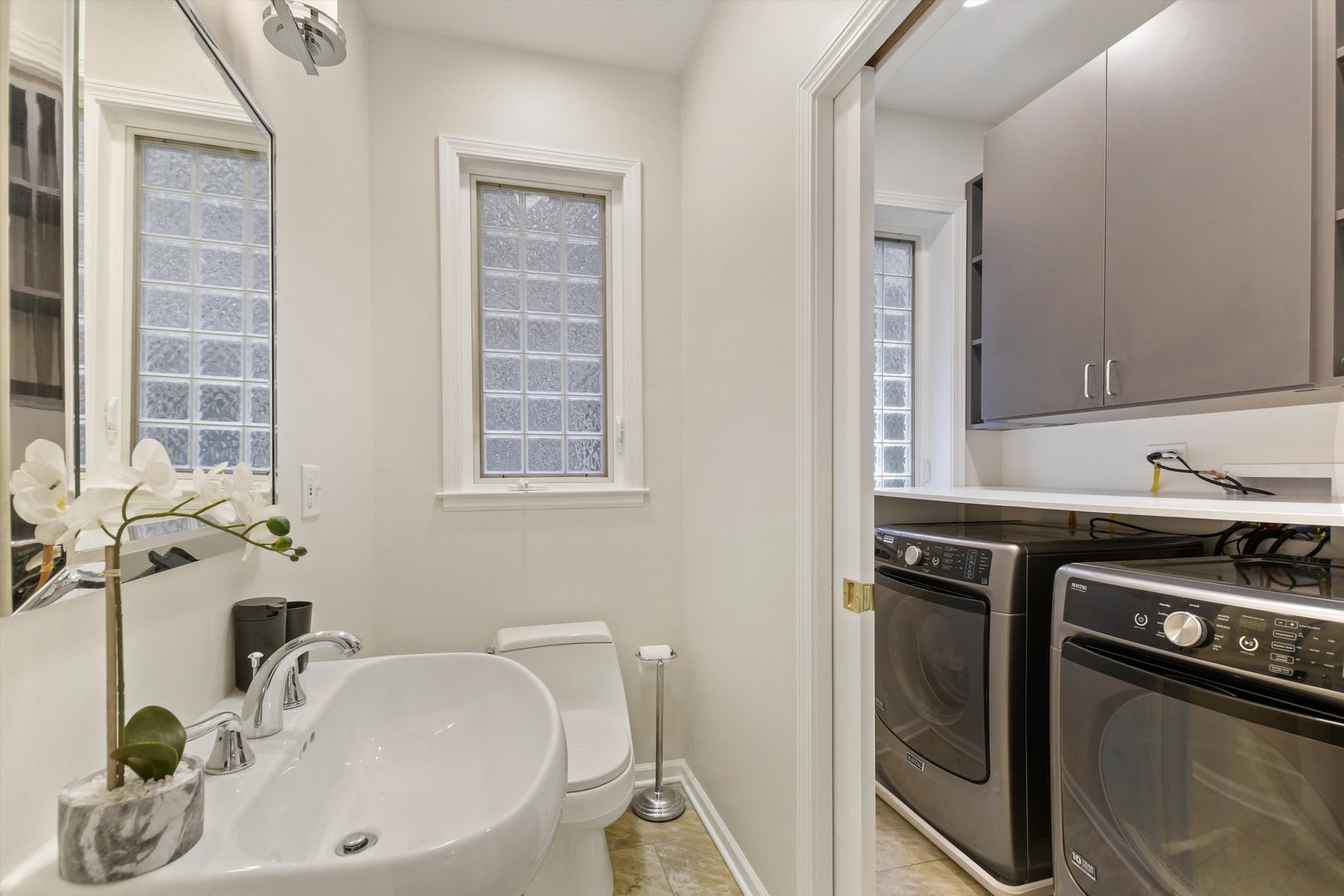 1447 West Flournoy Street Chicago, IL 60607 - Photo 15 of 41 a bathroom with a sink and a washing machine
