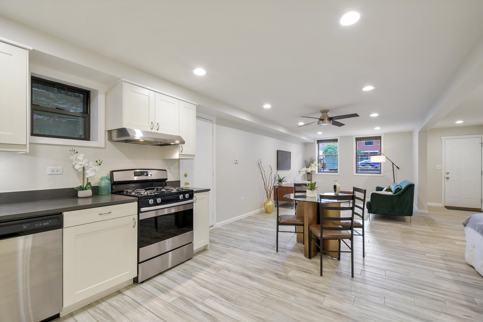 1447 West Flournoy Street Chicago, IL 60607 - Photo 25 of 41 a kitchen with stainless steel appliances kitchen island granite countertop a stove top oven a sink a counter space and cabinets