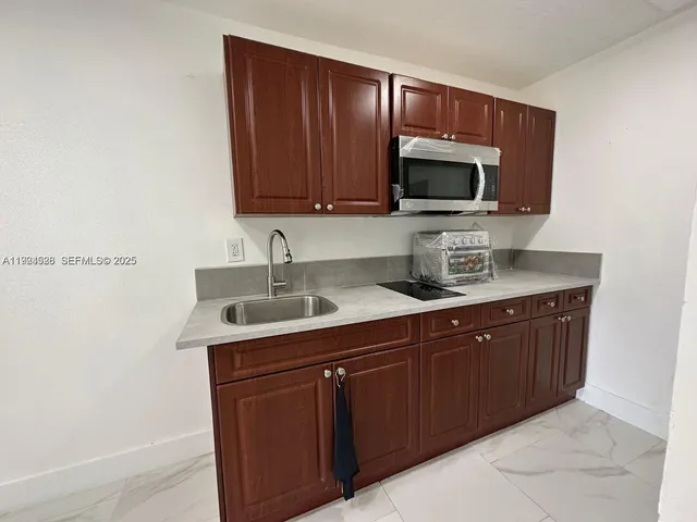 a kitchen with a sink and a microwave