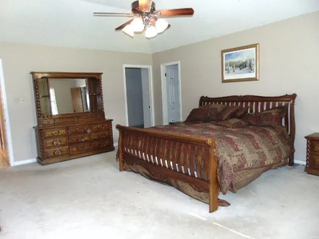 a spacious bedroom with a bed and a window