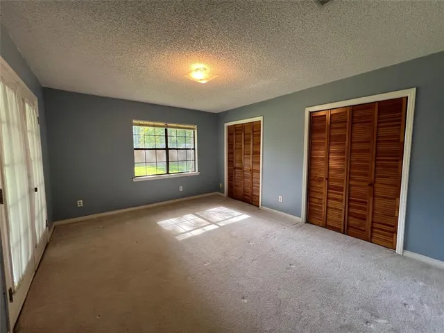 a bathroom with a granite countertop toilet sink and mirror