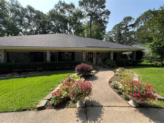 a front view of house with yard and green space