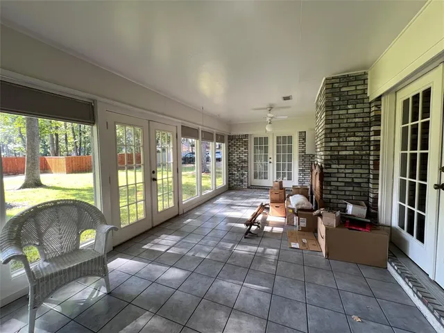 a living room with furniture and large windows