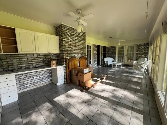 a view of a room with a large windows and plants
