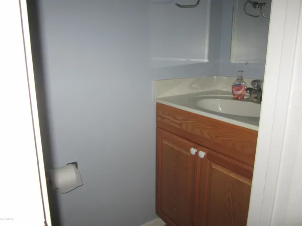 a bathroom with a granite countertop sink and vanity