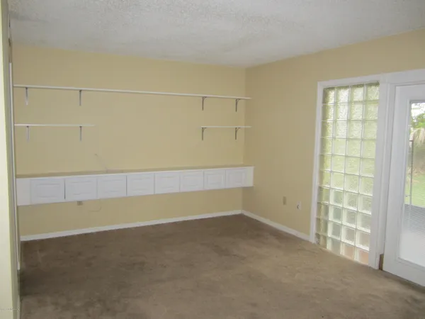 an empty room with a empty space and windows