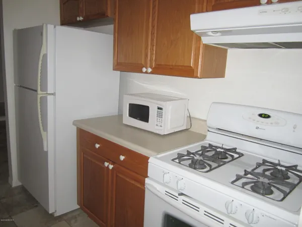 a kitchen with stainless steel appliances granite countertop a stove and a refrigerator
