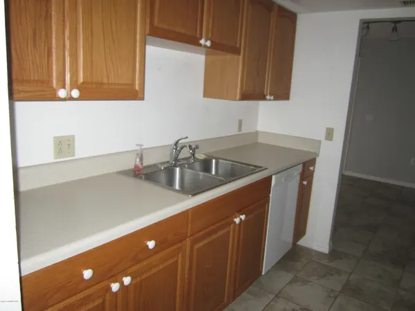 a kitchen with a sink cabinets and a window