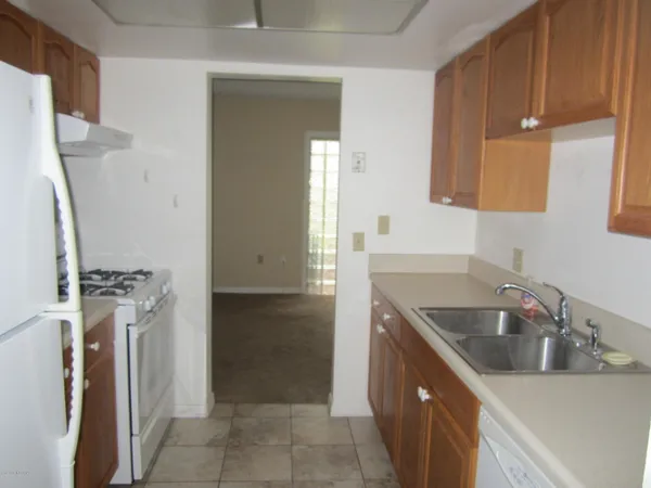 a kitchen with a sink stove and refrigerator