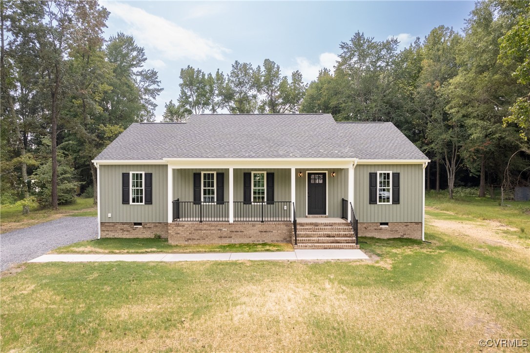 1304 Trimmers Shop Rd Point West Point, VA 23181 - Photo 1 of 12 a front view of a house with a yard table and chairs