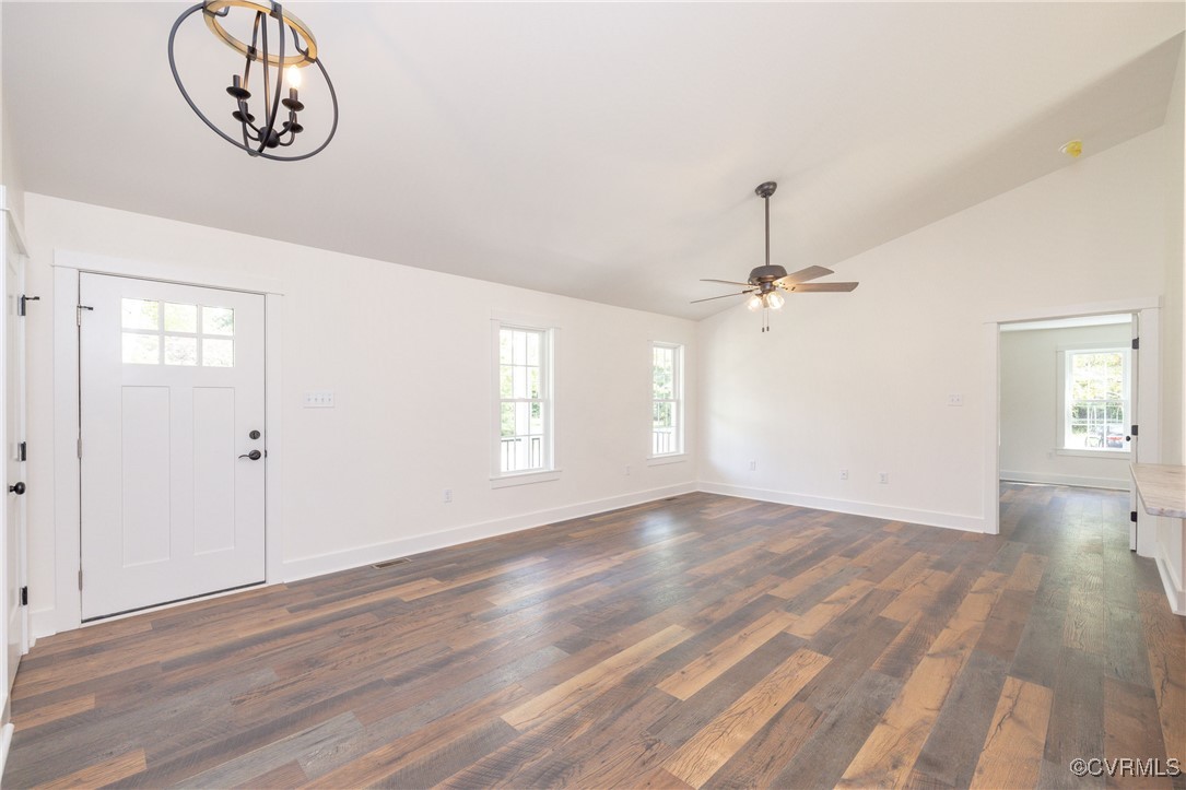 1304 Trimmers Shop Rd Point West Point, VA 23181 - Photo 4 of 12 an empty room with wooden floor chandelier fan and windows