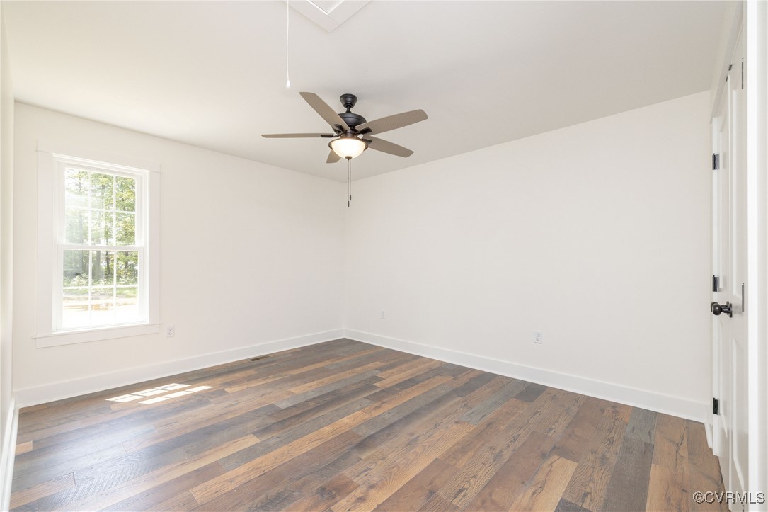 1304 Trimmers Shop Rd Point West Point, VA 23181 - Photo 6 of 12 wooden floor in an empty room with a window