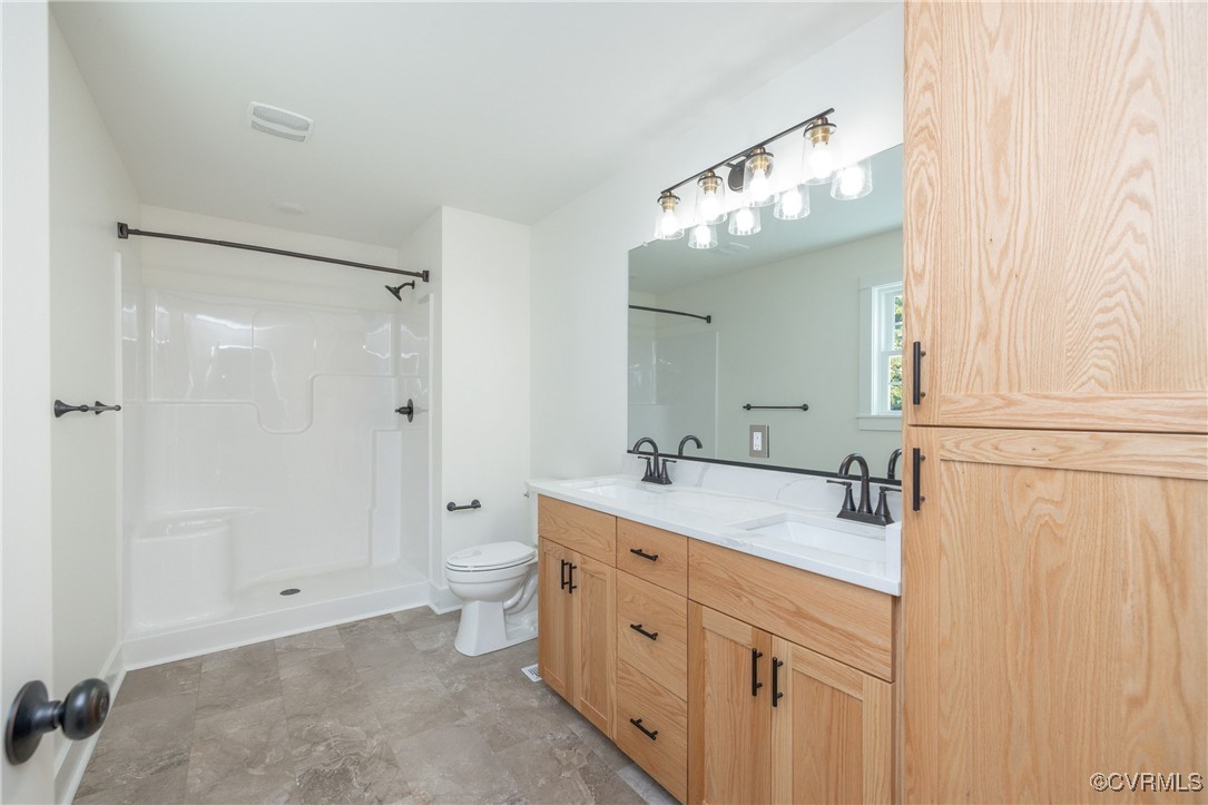 1304 Trimmers Shop Rd Point West Point, VA 23181 - Photo 7 of 12 a bathroom with a double vanity sink mirror and toilet