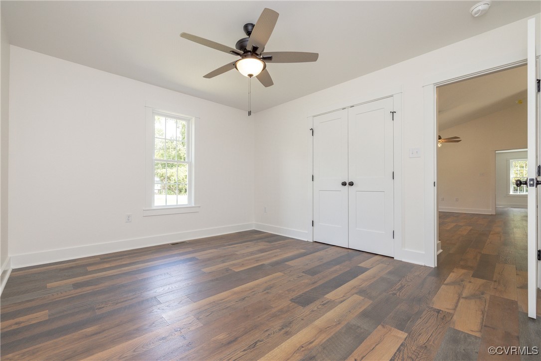 1304 Trimmers Shop Rd Point West Point, VA 23181 - Photo 10 of 12 an empty room with wooden floor fan and windows