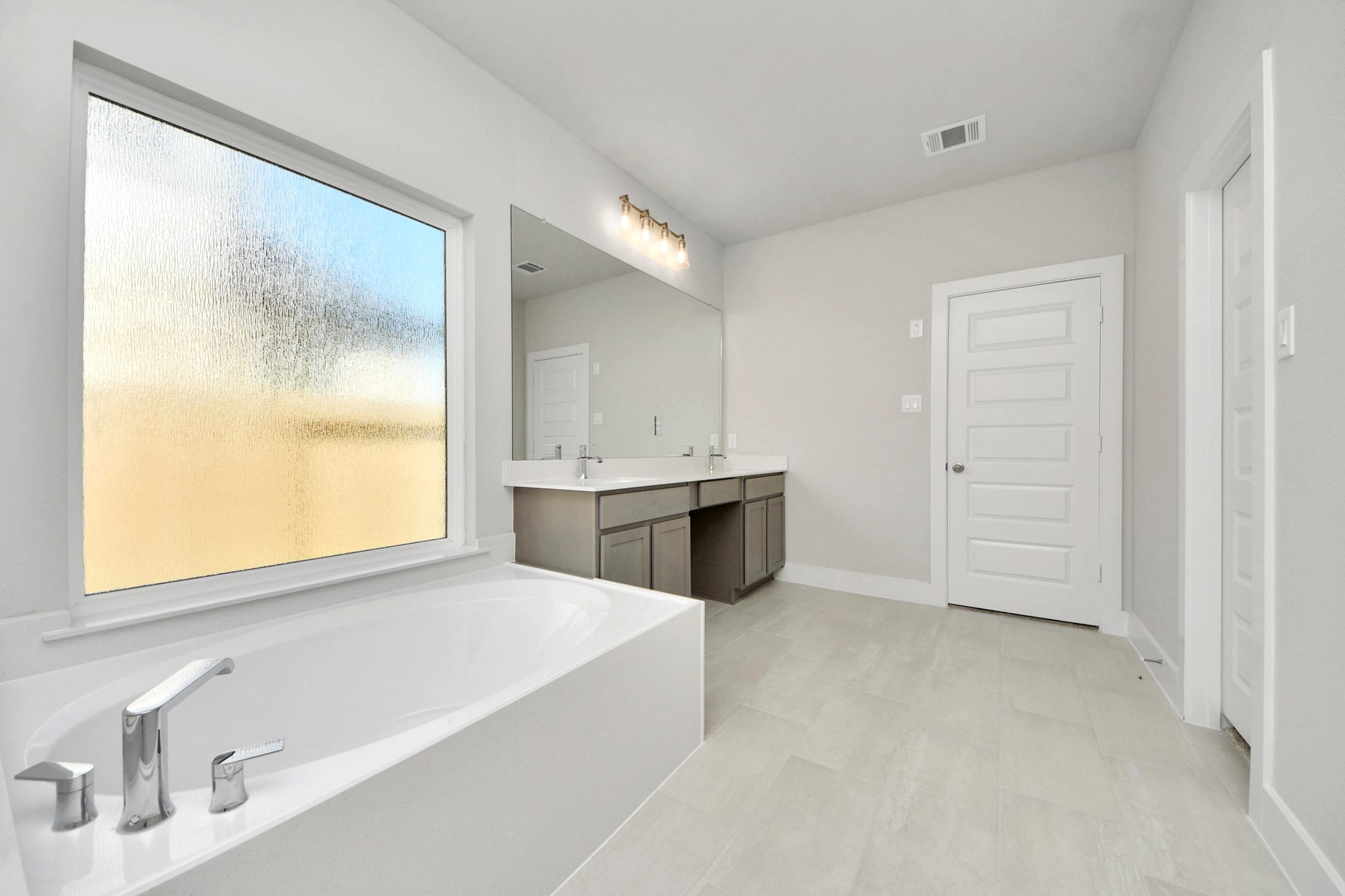 3042 Native Spg Drive Spring, TX 77373 - Photo 27 of 32 Indulge in a spa-like retreat within the confines of this primary bathroom. Delight in a spacious walk-in shower enveloped in stylish tile surround, unwind in a separate garden tub adorned with custom detailing. Sample photo of completed home with similar floor plan. Actual colors and selections may vary.